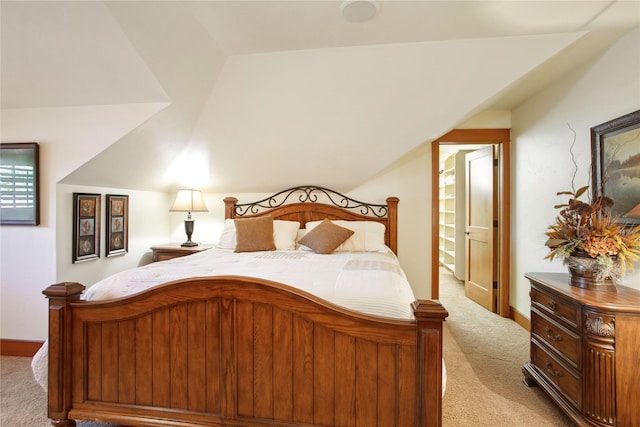 bedroom featuring baseboards, light colored carpet, and vaulted ceiling