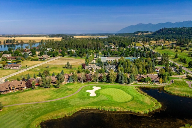 birds eye view of property featuring a water and mountain view, golf course view, and a residential view