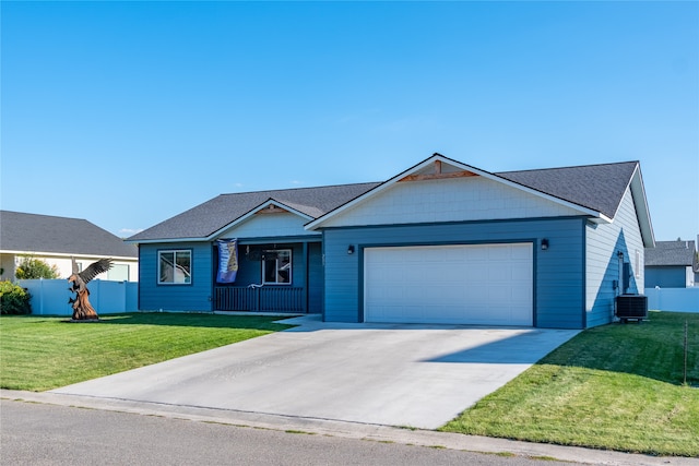 single story home featuring a garage, central AC unit, and a front lawn