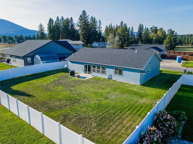 view of front of property with a mountain view and a front lawn