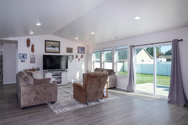 living room featuring dark wood-type flooring and vaulted ceiling