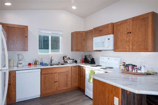 kitchen featuring vaulted ceiling, white appliances, dark wood-type flooring, kitchen peninsula, and sink