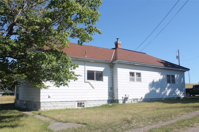 view of property exterior with a lawn