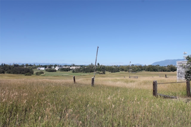 view of yard with a rural view and a mountain view