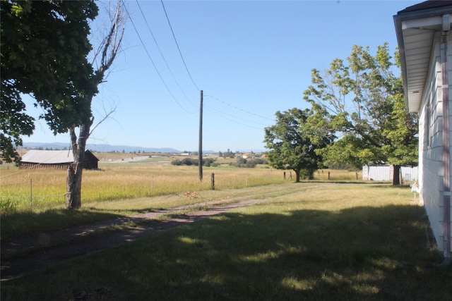 view of yard with a rural view