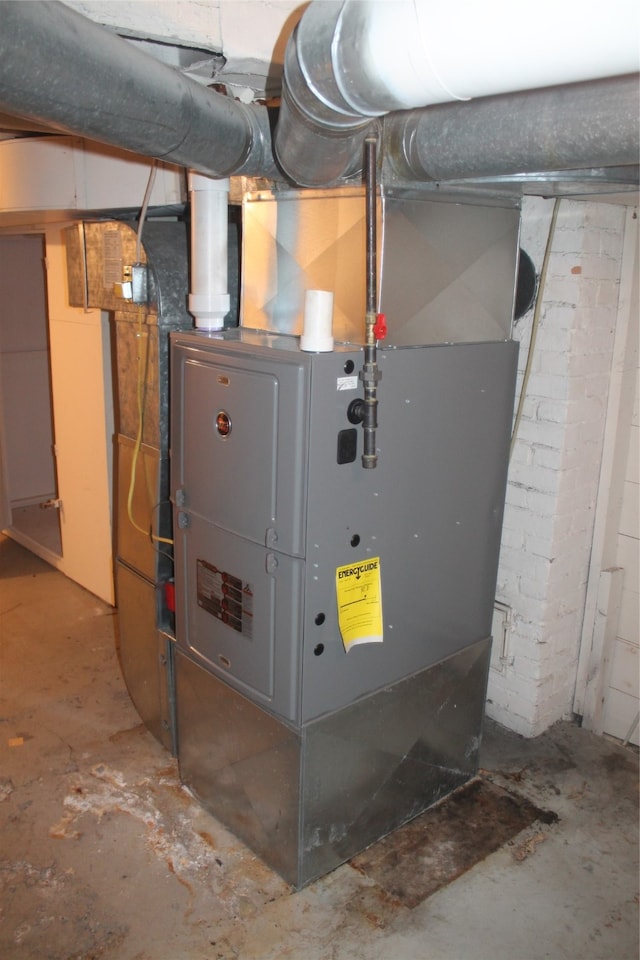 utility room featuring heating unit