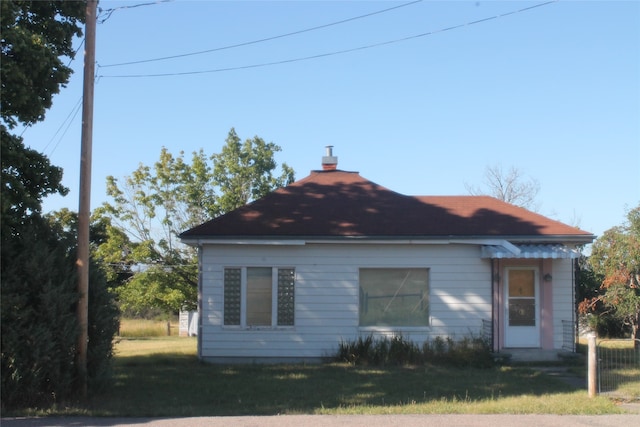 view of side of home featuring a lawn