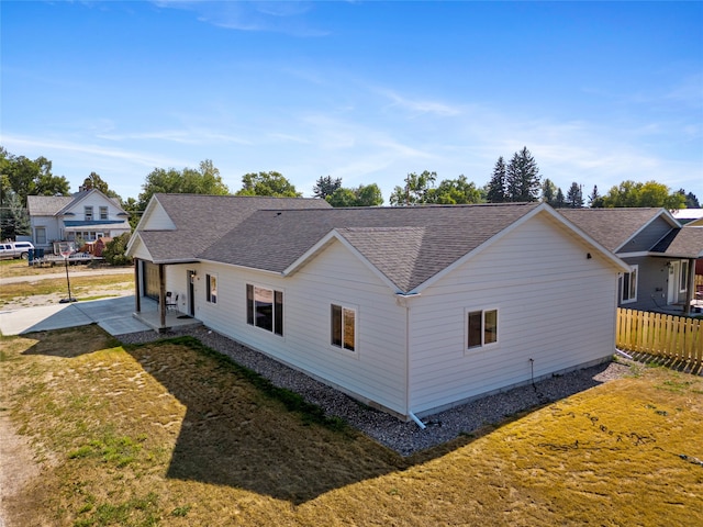 view of side of property featuring a yard and a patio area