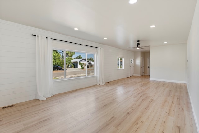 interior space with ceiling fan and light hardwood / wood-style floors