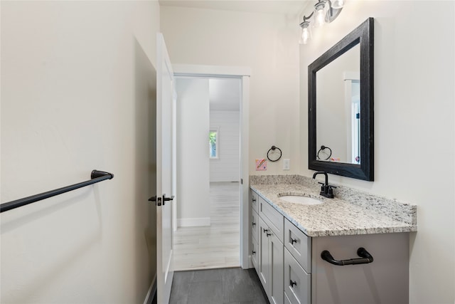 bathroom with vanity and wood-type flooring