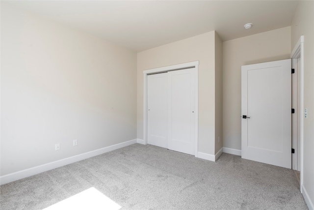 unfurnished bedroom with a closet and carpet floors