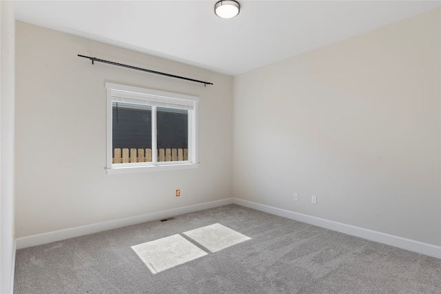 unfurnished room with light colored carpet