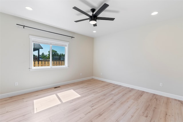 unfurnished room featuring ceiling fan and light hardwood / wood-style floors