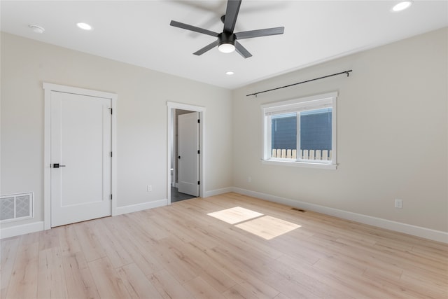 spare room featuring light wood-type flooring and ceiling fan