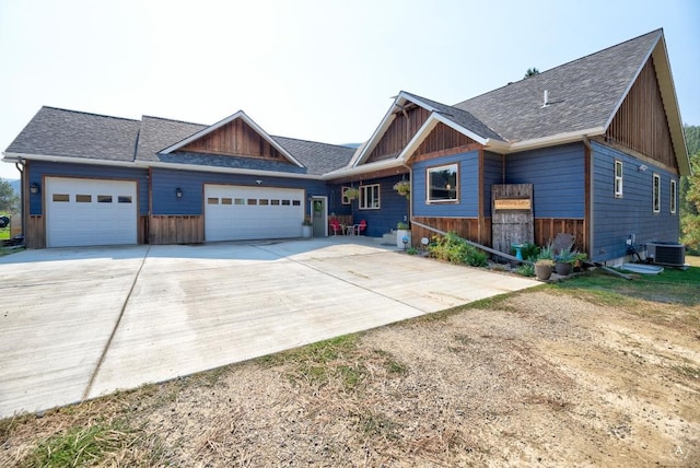 view of front of house with a garage and central AC unit