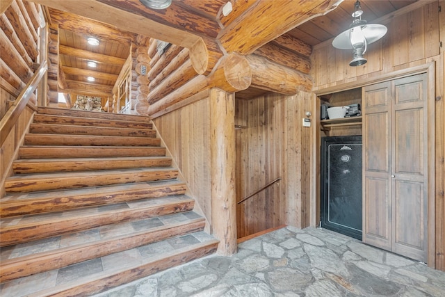 2100 Four Mile Way, Kalispell, MT 59901 - staircase featuring a wood ceiling with exposed beams, stone floors, log walls, and wood walls