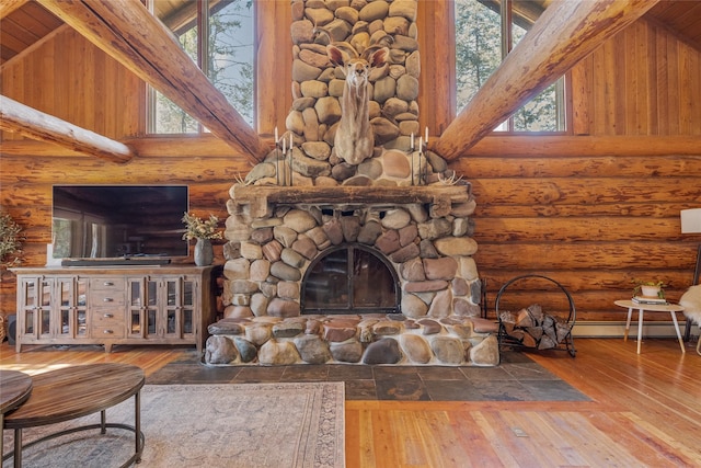 2100 Four Mile Way, Kalispell, MT 59901 - unfurnished living room featuring rustic walls, hardwood / wood-style flooring, a fireplace, beam ceiling, and high vaulted ceiling