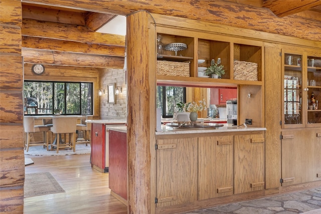 2100 Four Mile Way, Kalispell, MT 59901 - kitchen with light wood-style flooring, beam ceiling, healthy amount of natural light, light countertops, and open shelves