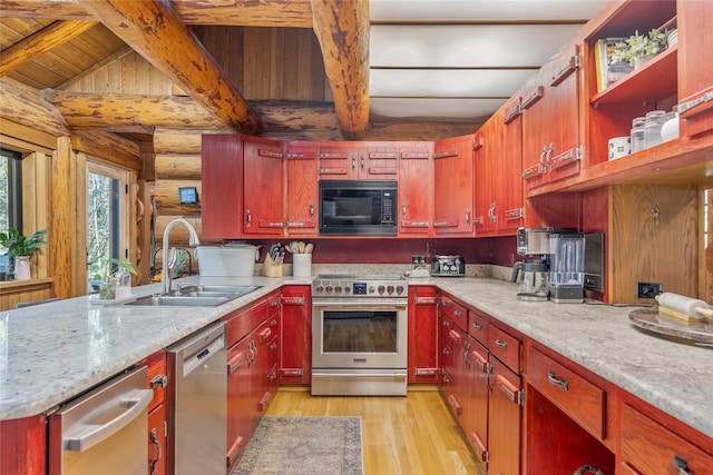 2100 Four Mile Way, Kalispell, MT 59901 - kitchen with stainless steel appliances, light wood-style floors, wooden ceiling, rustic walls, and a peninsula