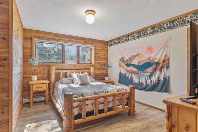 2100 Four Mile Way, Kalispell, MT 59901 - bedroom with a textured ceiling, light wood-style flooring, and a baseboard heating unit