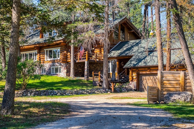 2100 Four Mile Way, Kalispell, MT 59901 - cabin with log exterior, stone siding, stairs, and driveway