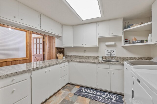 2100 Four Mile Way, Kalispell, MT 59901 - kitchen featuring washing machine and clothes dryer, open shelves, white cabinetry, and stone finish flooring