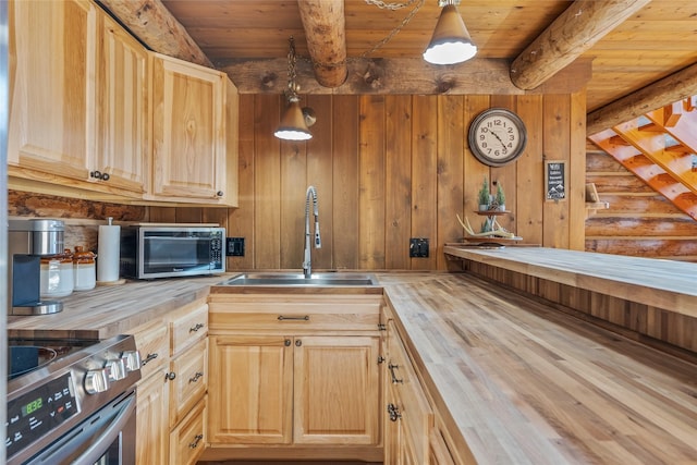 2100 Four Mile Way, Kalispell, MT 59901 - kitchen featuring wooden counters, stainless steel stove, light brown cabinetry, a wooden ceiling with exposed beams, and wood finished floors