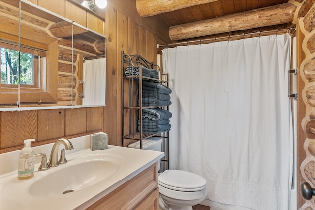 2100 Four Mile Way, Kalispell, MT 59901 - bathroom with vanity, curtained shower, wooden walls, and beamed ceiling