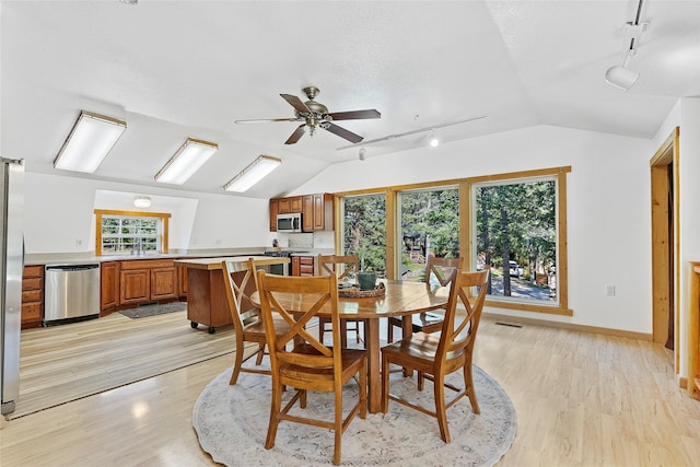 2100 Four Mile Way, Kalispell, MT 59901 - dining area featuring rail lighting, lofted ceiling, a ceiling fan, and light wood-style floors