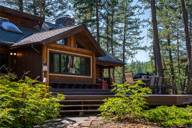 2100 Four Mile Way, Kalispell, MT 59901 - doorway to property with roof with shingles, a chimney, and a deck