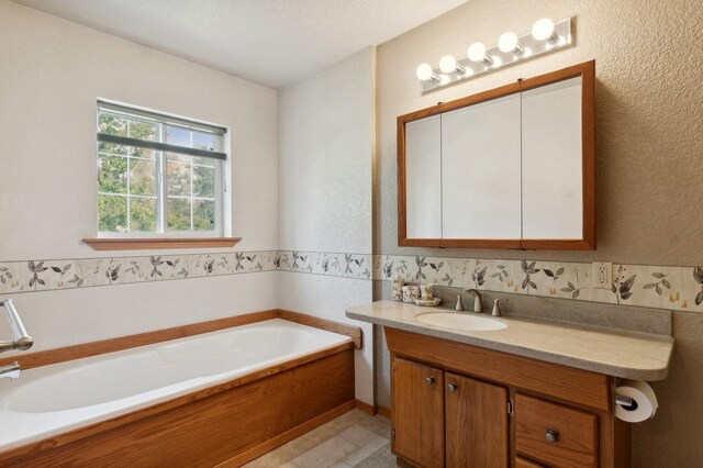 bathroom featuring a tub to relax in and vanity