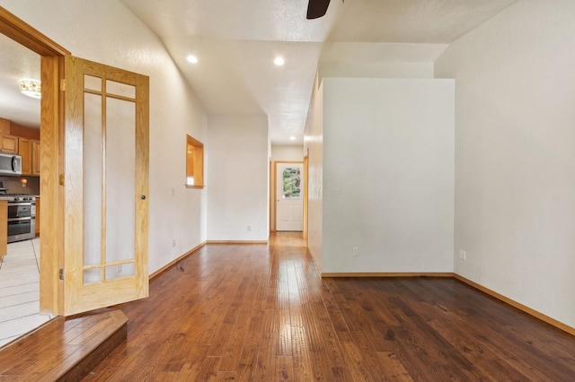 empty room featuring recessed lighting, baseboards, ceiling fan, and hardwood / wood-style flooring