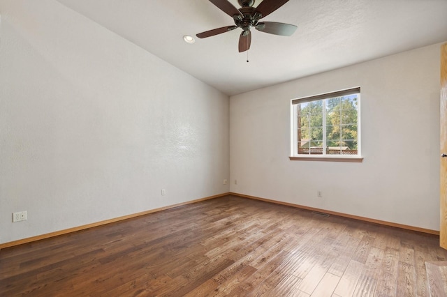 spare room with ceiling fan, baseboards, and wood finished floors