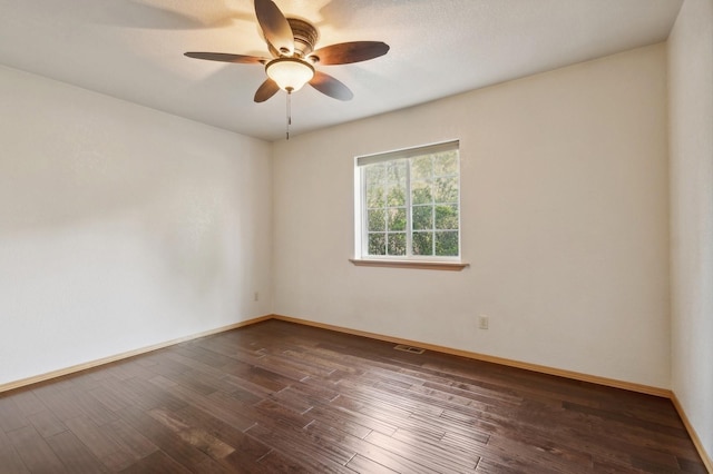 unfurnished room featuring ceiling fan and dark hardwood / wood-style flooring