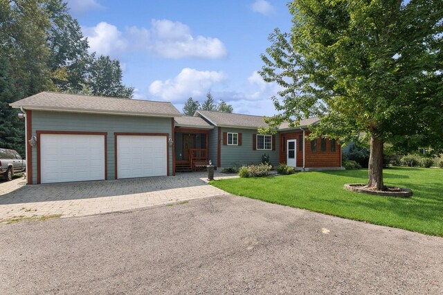 ranch-style home featuring a front yard and a garage