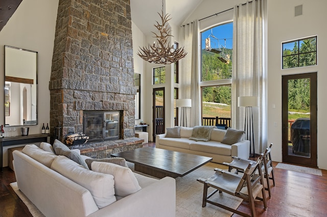 living room with high vaulted ceiling, plenty of natural light, and wood-type flooring