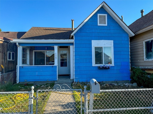 1327 Farrell St, Butte, MT 59701 - bungalow-style house with a porch, a gate, a shingled roof, and a fenced front yard