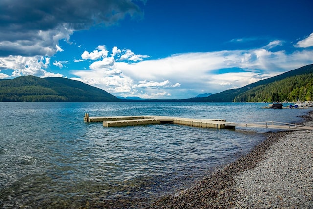 view of dock with a water and mountain view