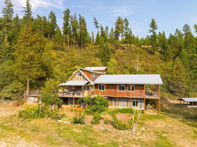 rear view of house featuring a wooden deck