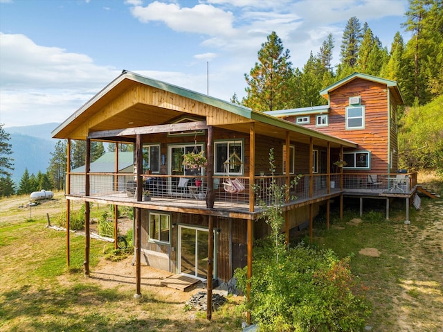 back of house featuring a deck with mountain view