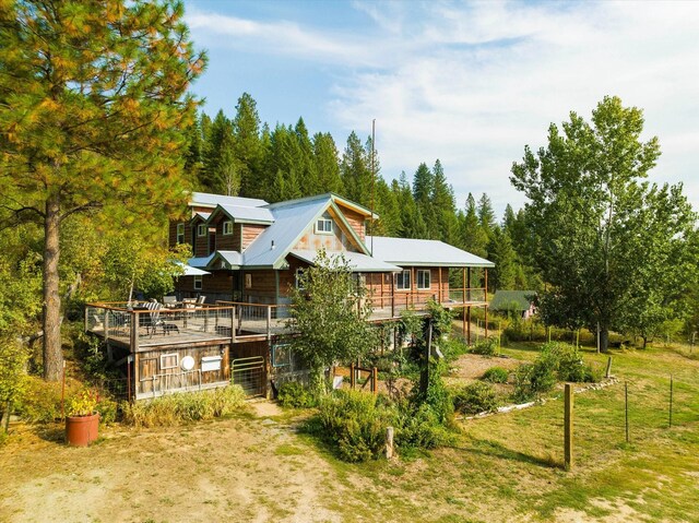 rear view of property featuring a deck