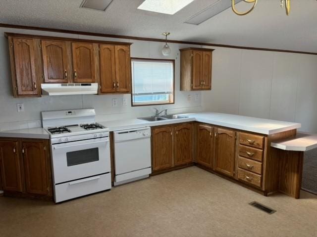 kitchen featuring white appliances, visible vents, ornamental molding, a sink, and under cabinet range hood