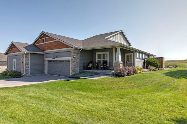 view of front of home featuring a front lawn, a porch, and a garage