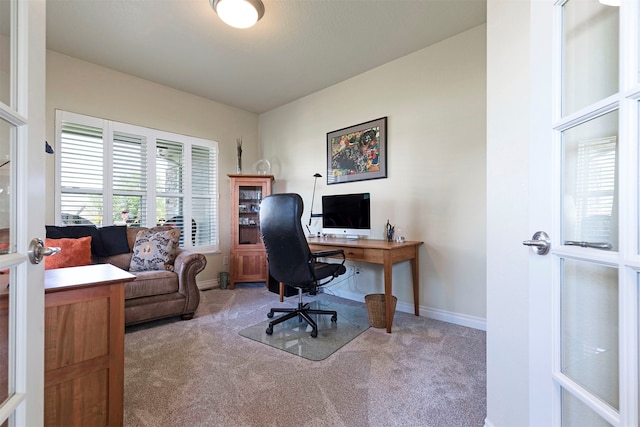 carpeted office with french doors