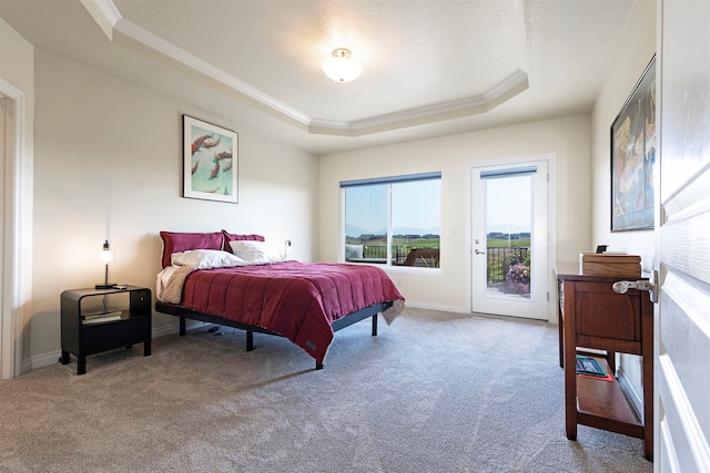 bedroom featuring access to outside, a tray ceiling, light carpet, and ornamental molding