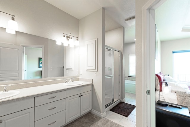 bathroom with vanity, tile patterned floors, a textured ceiling, and a shower with shower door