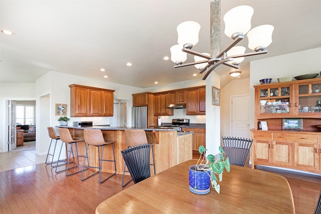 dining space featuring light hardwood / wood-style flooring and a chandelier