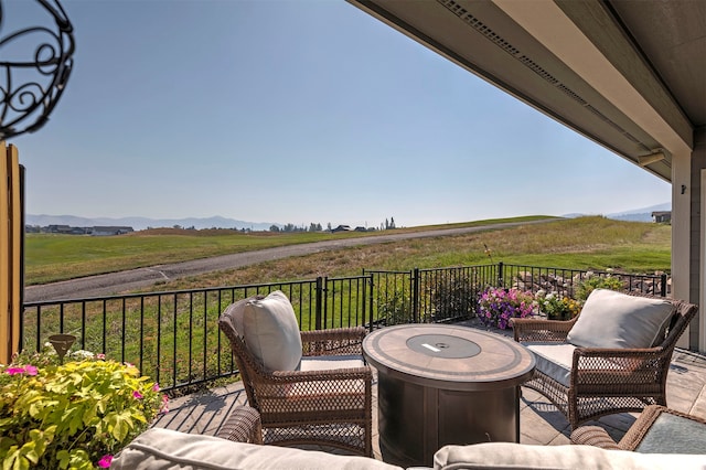 wooden deck with a rural view and an outdoor hangout area