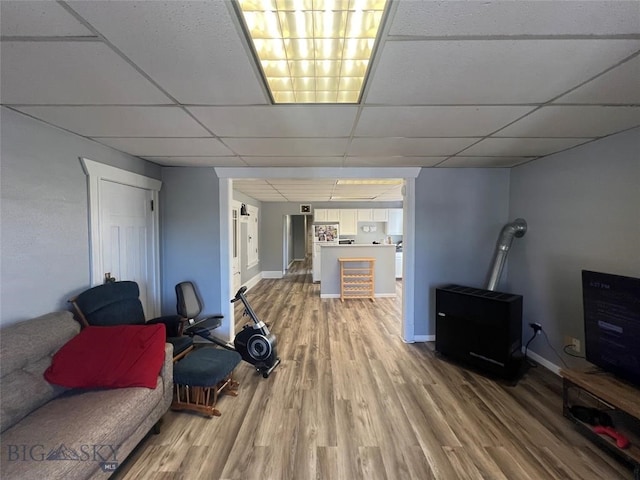 living room with a drop ceiling and hardwood / wood-style floors