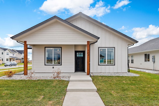 view of front of house featuring a front lawn, board and batten siding, and a porch